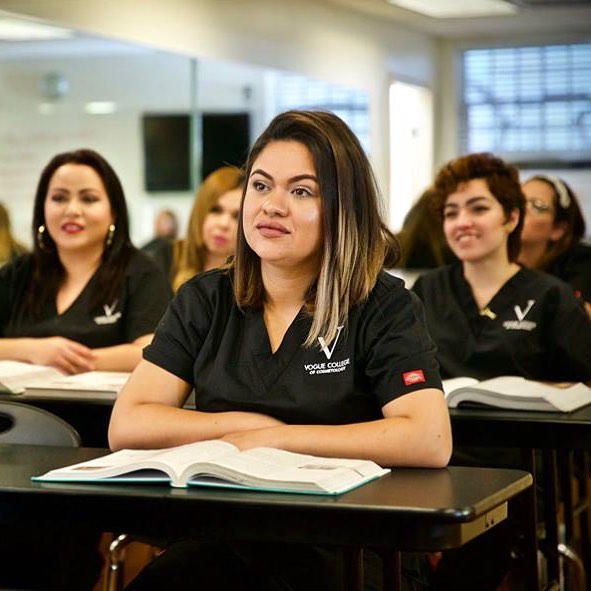 Students at Vogue College of Cosmetology learning in a classroom