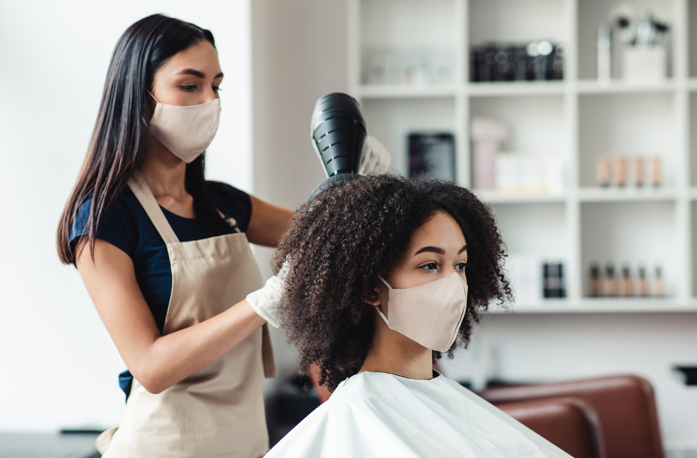 women getting her hair done by a stylist