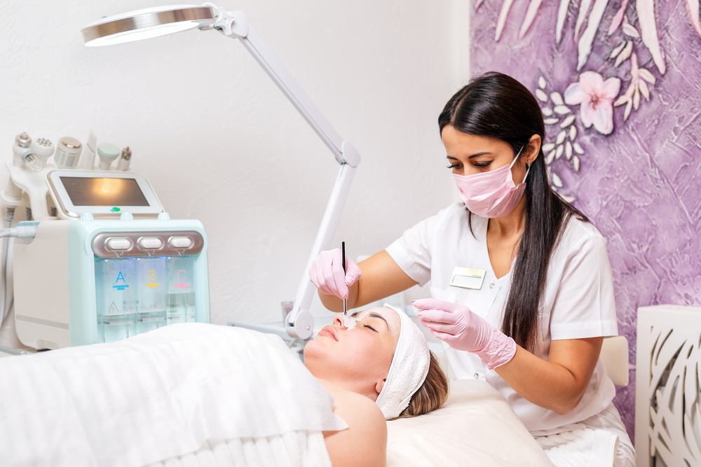 women getting a facial from an esthetician 