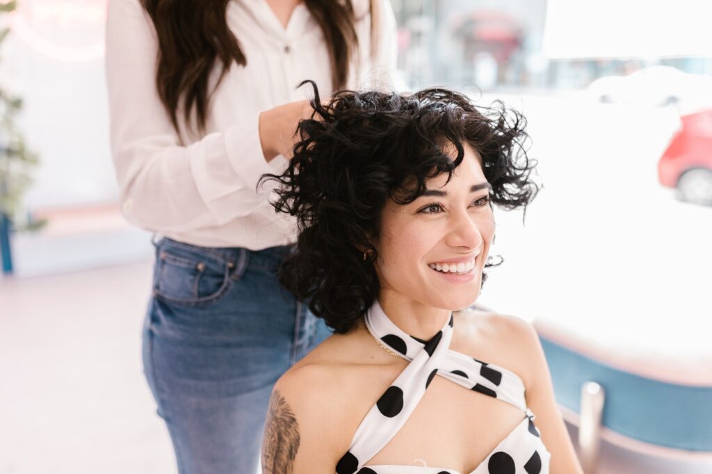 woman sitting in a salon chair getting her hair done