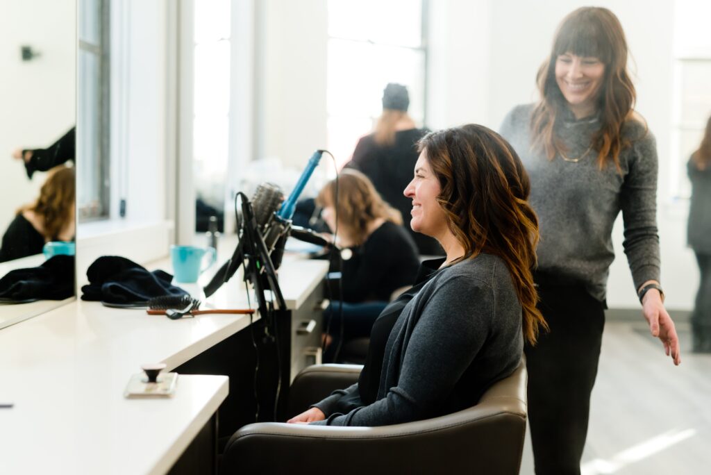 woman doing another woman's hair in the salon