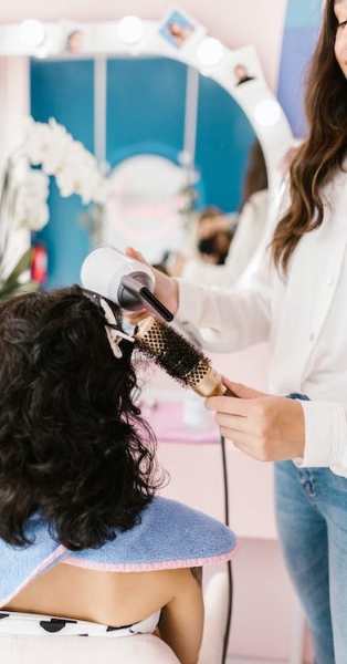 Hair dresser questions Hair dresser brushing a client's hair